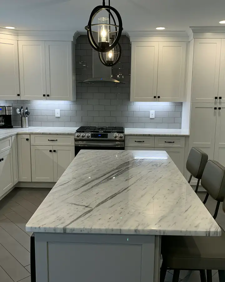 A white quartz island under glass pendants